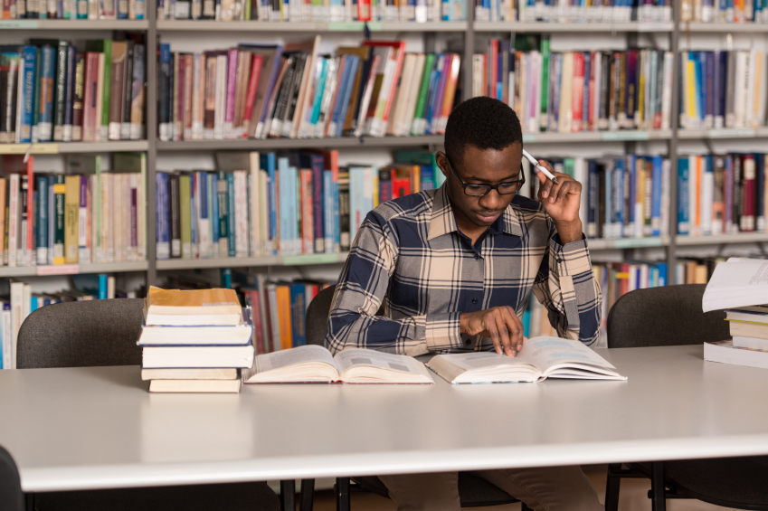 African Man Studying In A Library