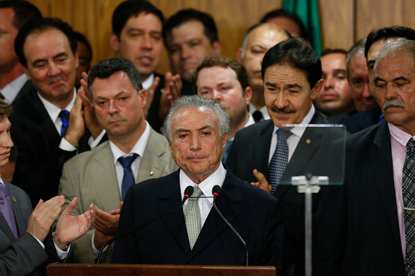 BRASILIA, BRAZIL - MAY 12: Brazil's interim President Michel Temer (C) attends a signing ceremony for new government ministers at the Planalto presidential palace after the Senate voted to accept impeachment charges against suspended President Dilma Rousseff on May 12, 2016 in Brasilia, Brazil. Rousseff has been suspended from her presidential duties and will face a Senate trial for alleged manipulation of government accounts. (Photo by Igo Estrela/Getty Images)
